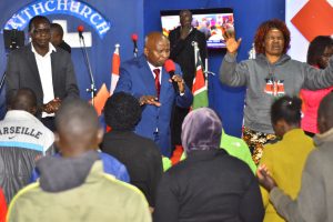 Dr. Nicholas Chepkoiywo praying for congregants